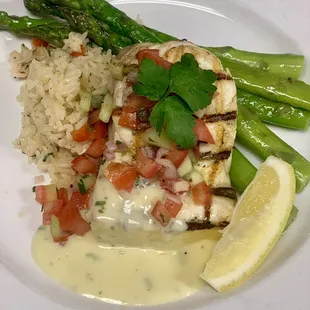 Fresh Catch Special! Grilled Halibut with Mediterranean Salsa and Beurre Blanc. Topped with a Roasted Red Pepper Basamati Rice and Asparagus