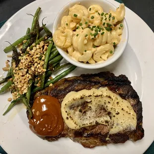 12oz Ribeye with Garlic Crust, and house-made steak sauce with your choice of 2 sides!