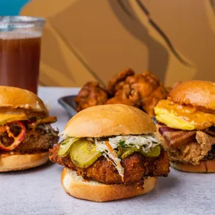 three fried chicken sandwiches and a drink