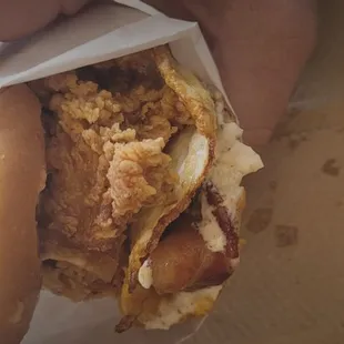 Breakfast chicken sandwich with over hard egg.