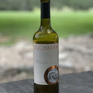 a bottle of wine on a picnic table
