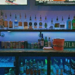a bar with a lot of bottles of alcohol
