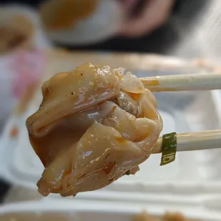 chopsticks holding a piece of food