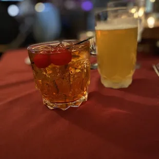a drink and a glass of beer on a table