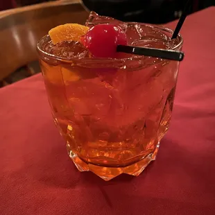 a drink with a cherry garnish