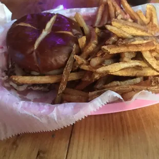 Single cheeseburger with pretzel bun and grilled onions with Swiss cheese!!