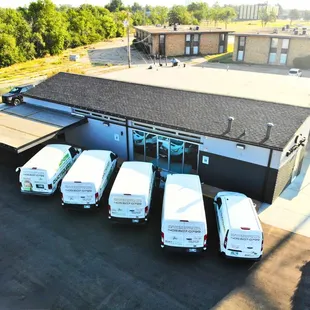 Outside our new building with our working Vans.