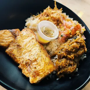 a plate of food including fish, rice and vegetables