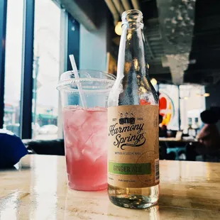 a bottle and a drink on a table