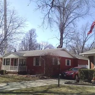 a red house with a flag flying in front of it
