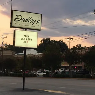 a sign for a restaurant on the corner of a street