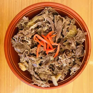a bowl of beef and carrots