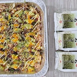 Sushi Bake  Layered by Sushi Rice, Yaki tamago,  Imitation Crab, Salmon, Tuna, Furikake, Tobiko Avocado,  Served by crispy roasted seaweed