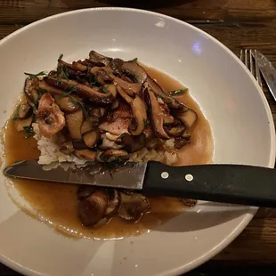 a plate of food with mushrooms and rice