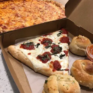Cheese pizza, fresh mozzarella pizza and garlic knots