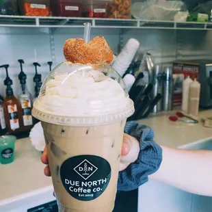 a hand holding a cup of coffee