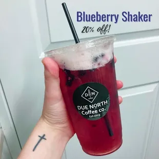 a hand holding a blueberry shaker