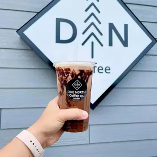 a hand holding a cup of coffee