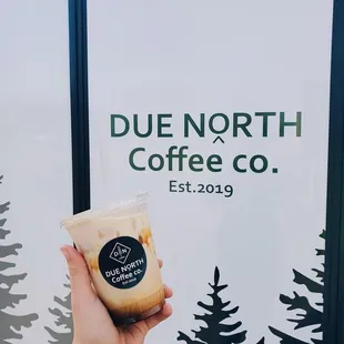 a hand holding a cup of coffee