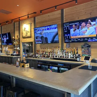 a bar with multiple televisions