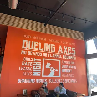 two men sitting on a couch