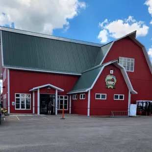 a red barn with a green roof