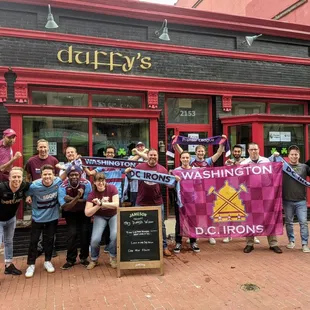 a group of people holding up a banner