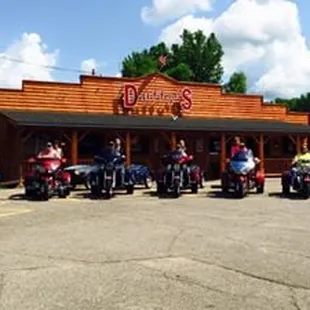 a group of motorcycles parked in front of the restaurant
