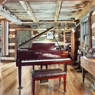 Baby grand piano in The Cabin.