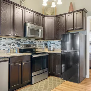 Modern kitchen with dishwasher in Sugar Maple Suite.