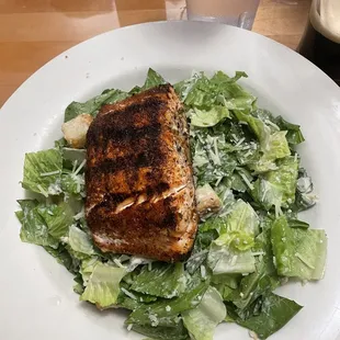a plate of salad with chicken and lettuce