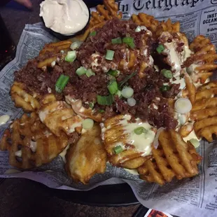 Supreme fries covered in bacon and queso. I&apos;m sorry arteries