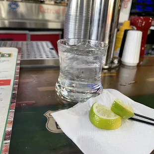 a glass of water and a slice of lime