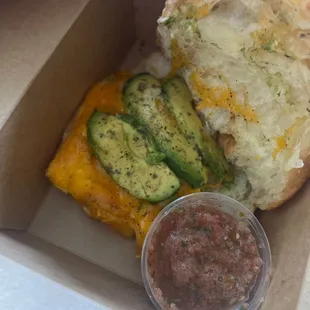 Brekki sandwich on croissant with avocado and fresh salsa