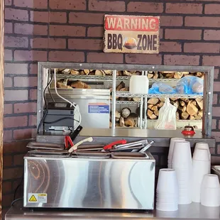 Note the racks of split wood on the shelving seen through the service window. These folks know their smoke!!