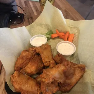 a basket of chicken wings and carrots