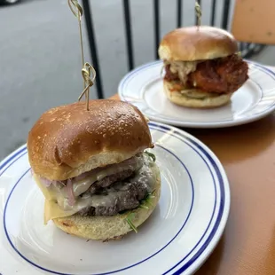 two hamburgers on plates
