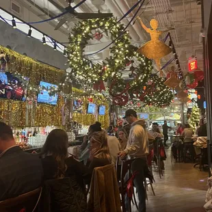 people sitting at tables in a restaurant