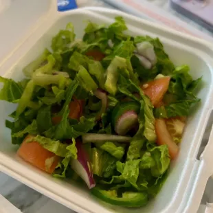 a salad in a styrofoam container