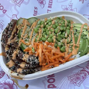 Small Poke Bowl:  Seared Tuna, carrots, avocado, edamame, cucumber, spicy mayo, sesame seeds.