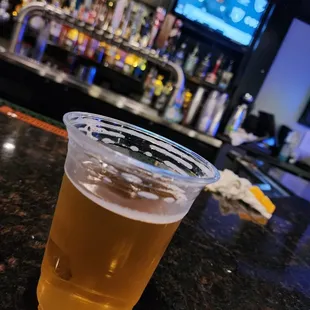  a beer in a plastic cup