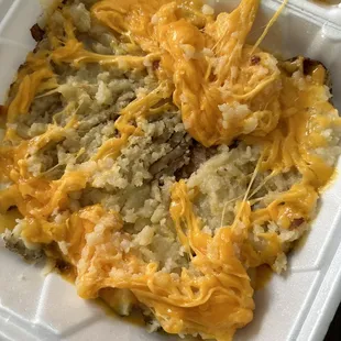 ows cheese being drizzled over a dish