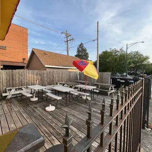 a patio with tables and an umbrella