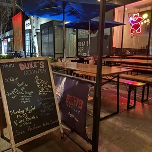 a chalkboard sign on a sidewalk