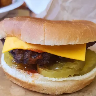 Hand-packed cheeseburger with pickles, onion, mustard, and ketchup, $5.75.