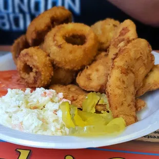 Chicken tenders, onion rings, and coleslaw.
