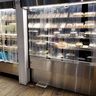 Deli section with a variety of sandwiches and salads.