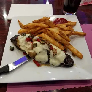 Smothered NY Strip steak with fries