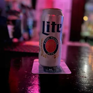 a can of beer sitting on a table