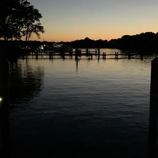 a group of people on a dock at dusk